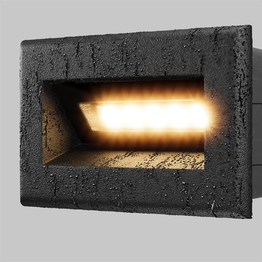 Applique encastrable bosca noire texturée avec lumière led chaude pour éclairage d’une allée extérieure