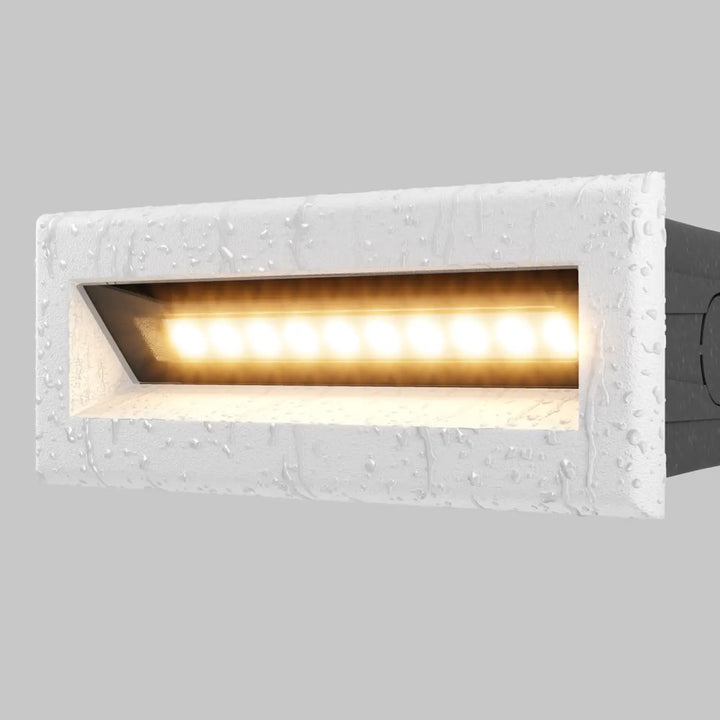 Applique encastrable extérieure bosca en led rectangulaire blanche texturée avec éclairage jaune chaud pour allée