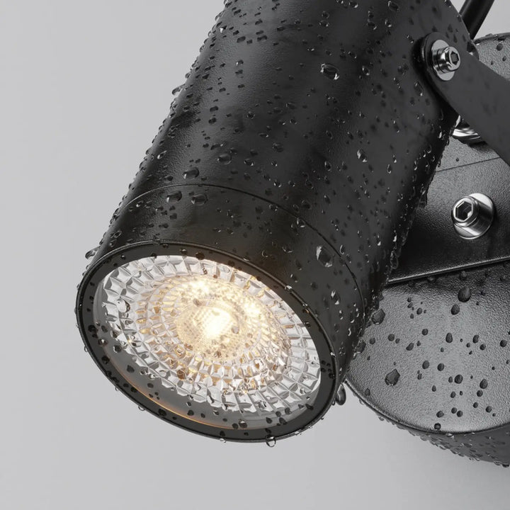 Applique extérieure scope projecteur orientable en acier noir avec finition texturée et ampoule led sous lentille facettée