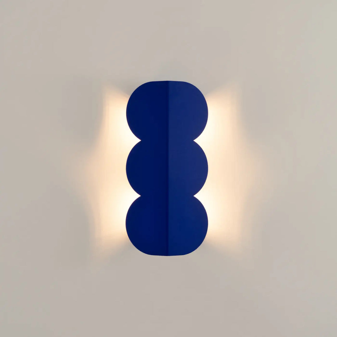 Applique murale biscuit outremer en bleu marine composee d’une lampe avec forme ondulée caractéristique moderne