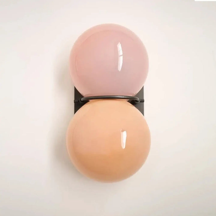 Applique murale gemini double boule en verre sphérique pastel rose et pêche avec support métal noir pour décoration intérieure