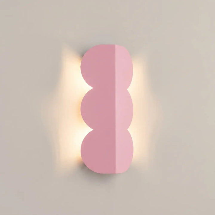 Applique murale BISCUIT rose allumée, halo sur le mur