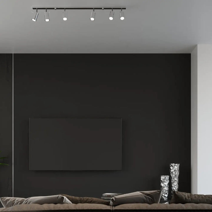 Applique murale ring noire avec cinq spots orientables pour platine murale au-dessus d’un lit moderne
