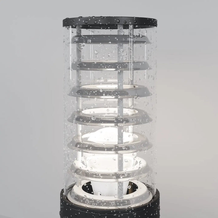 Borne extérieure Bronx en verre transparent avec structure métallique noire et anneaux cylindriques empilés