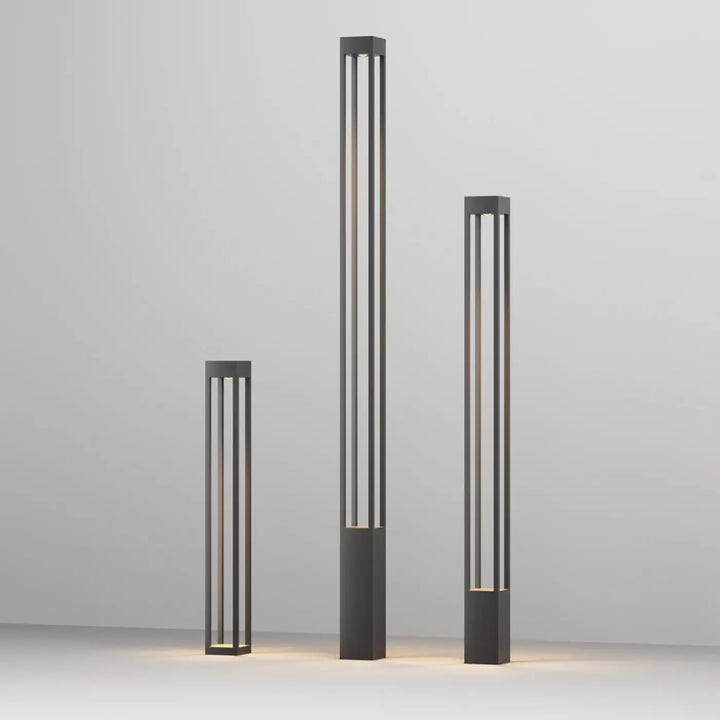 Borne extérieure elbe carrée avec profil carré en aluminium gris et lumière chaude dans un cadre métallique noir minimaliste