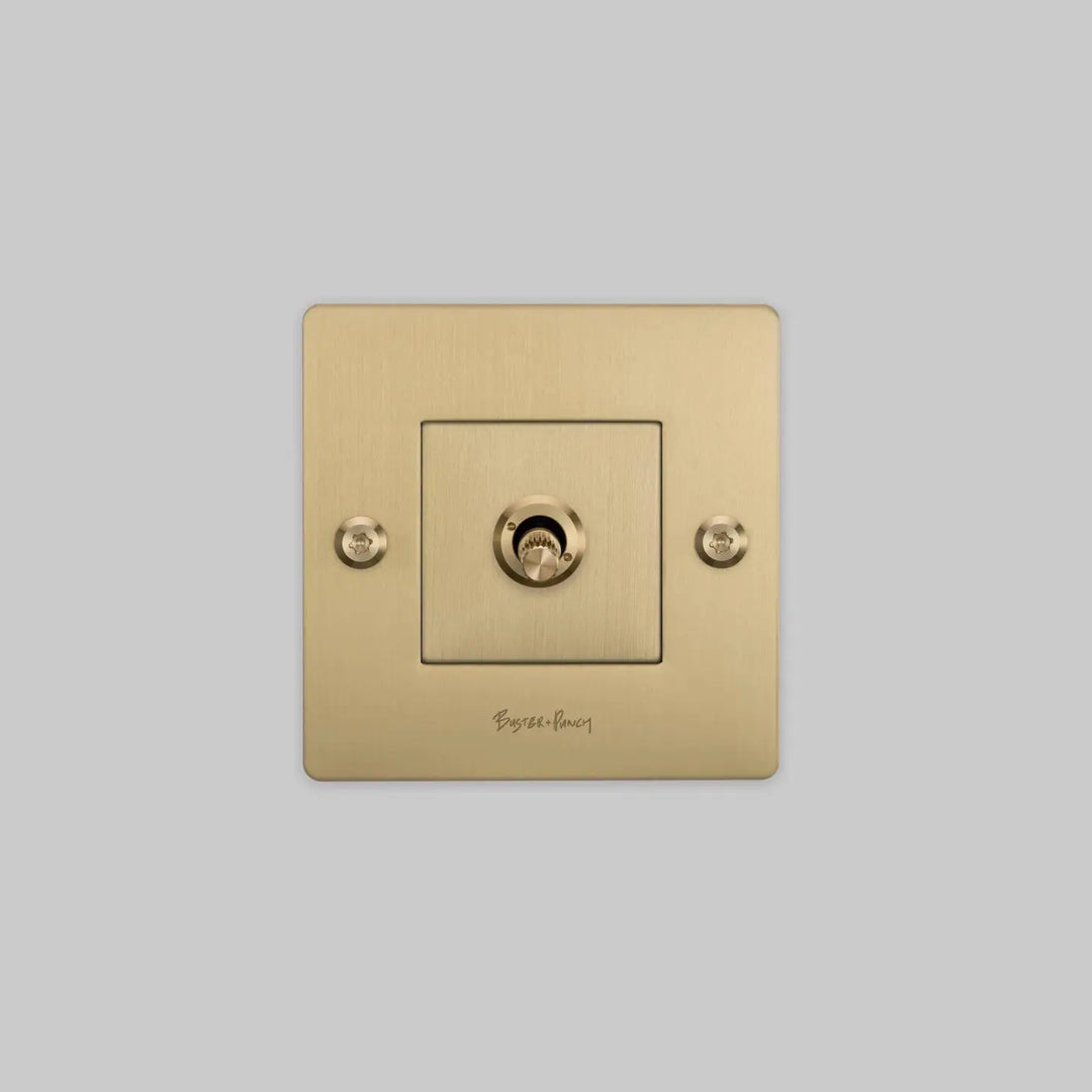 Interrupteur à levier Toggle à gravure alignée avec logo doré, finition laiton #couleur_dor