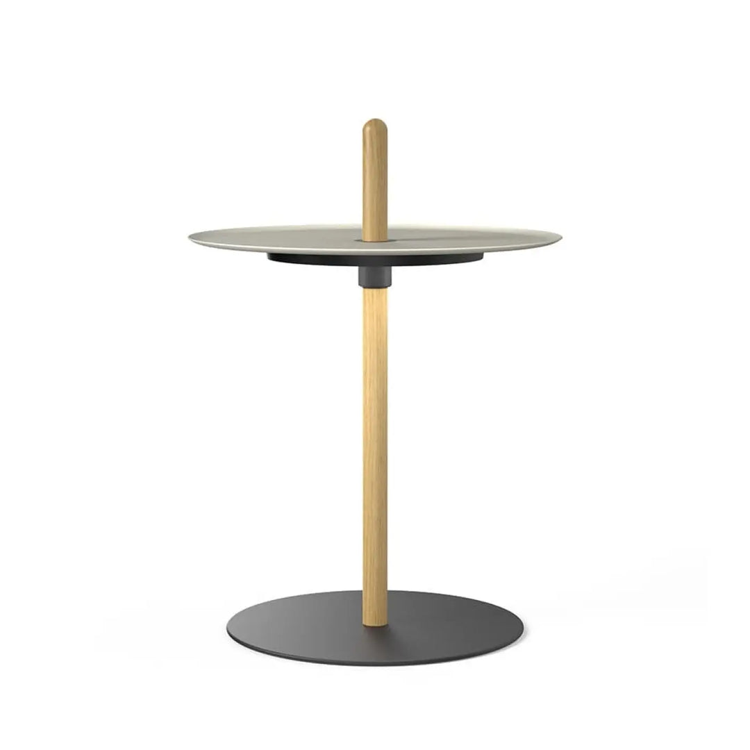 Lampe guéridon Nivél sans fil à côté d'un lit