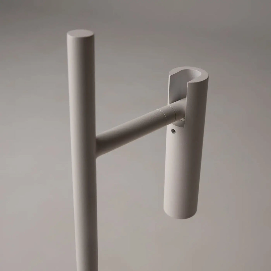 Minimalist white metal coat rack with sleek cylindrical design and horizontal arm for garment hanging by lampe de chevet estudo liseuse led