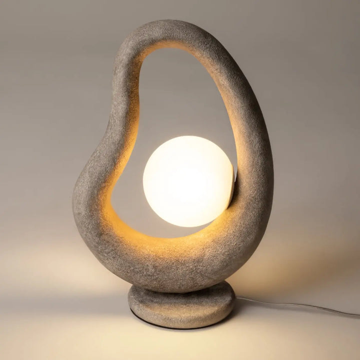 Lampe à poser opuS avec socle sculptural gris texturé en pierre et bulb sphérique blanc, objet d’art wabi-sabi
