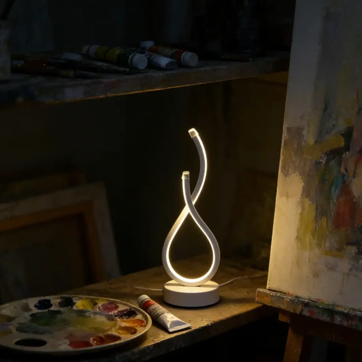 Lampe de table infinia avec boucle lumineuse blanche led design moderne silhouette sculpturale pour intérieur élégant
