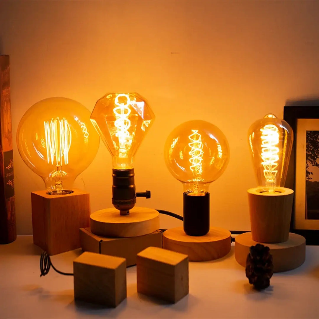 Lampe de table loxia avec quatre ampoules edison vintage à filament chaud sur socles en bois de tailles variées