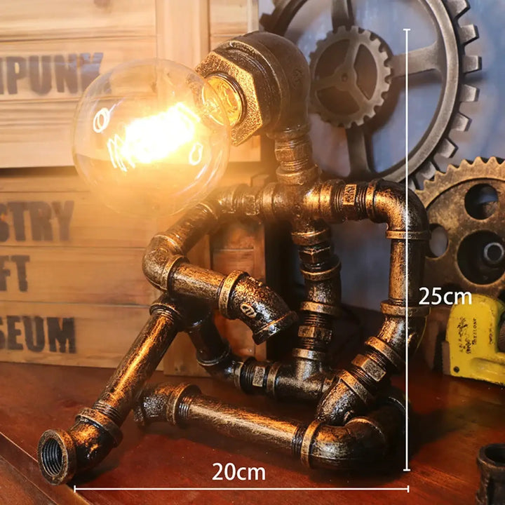 Lampe de table ironix style industriel en métal laiton foncé avec ampoule lumineuse pipe robot design éclatant