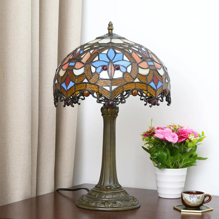 Lampe de table Nanih style vintage avec abat-jour en verre teinté bleu orange crème et base en bronze ornée