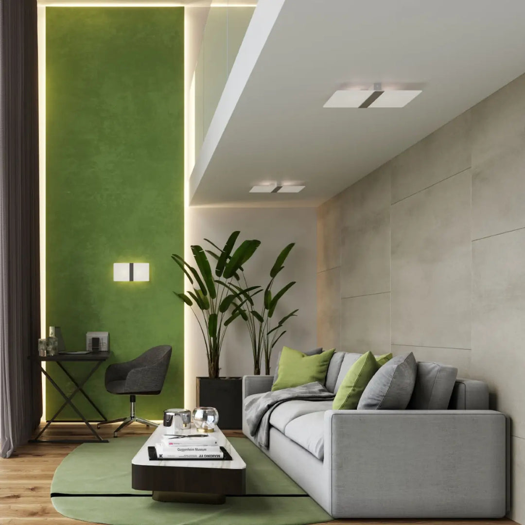 Luminaire plafonnier azalia fonctionnel avec verre blanc met pour chambre à coucher à côté d’un canapé gris avec coussins verts et gris