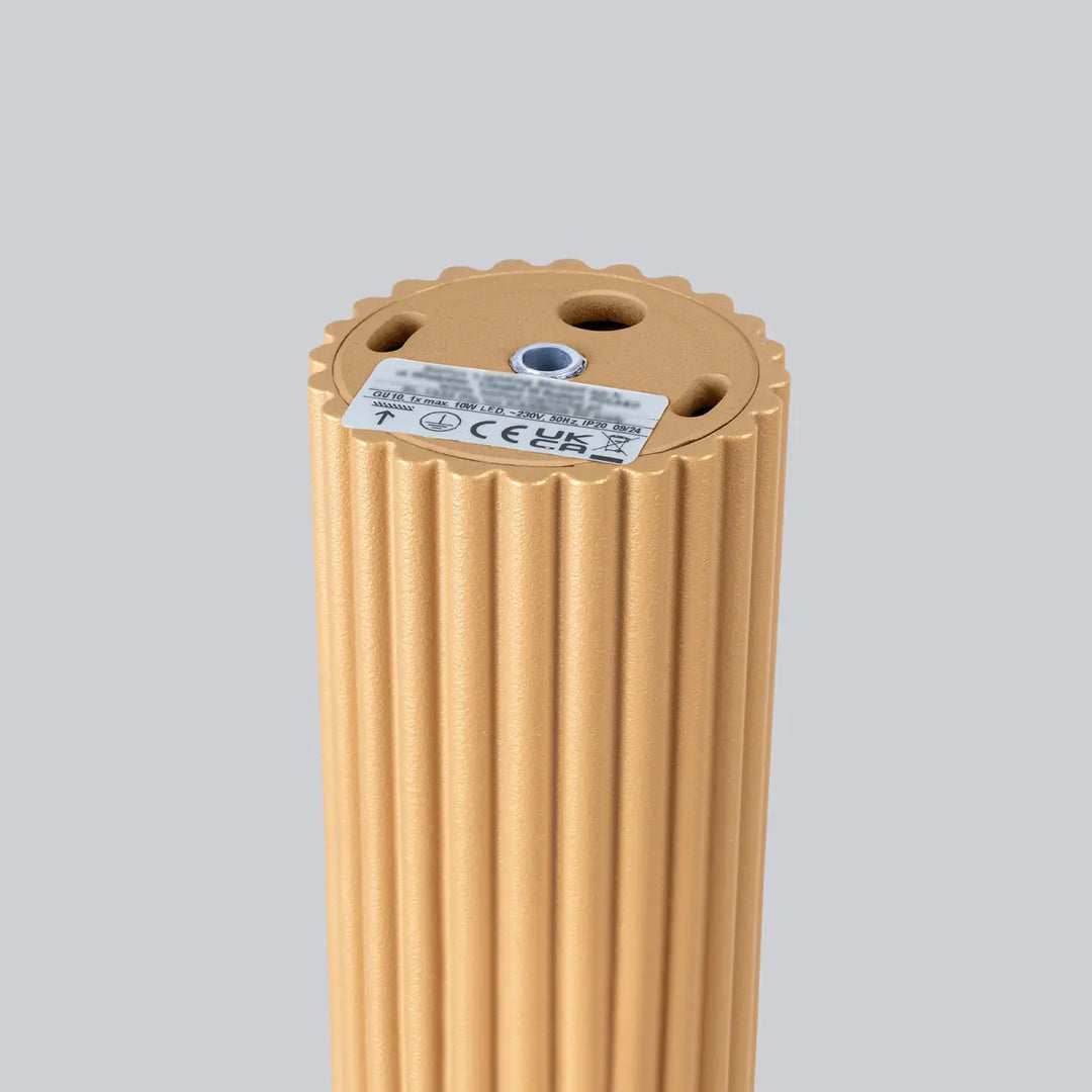 Base cylindrique dorée ribbée avec surface texturée et trous de montage pour plafonnier karbon design minimaliste