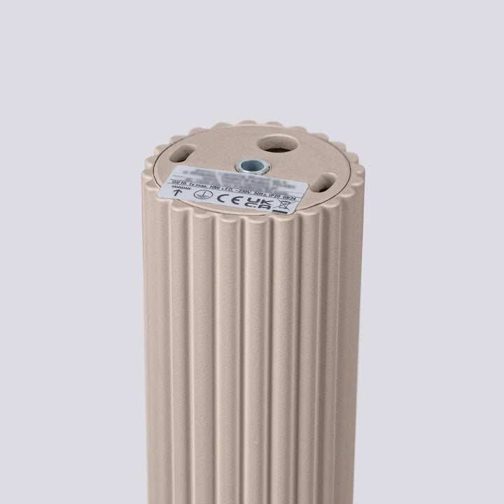Beige ribbed electric heater with circular top and certification labels for plafonnier karbon allie design minimaliste