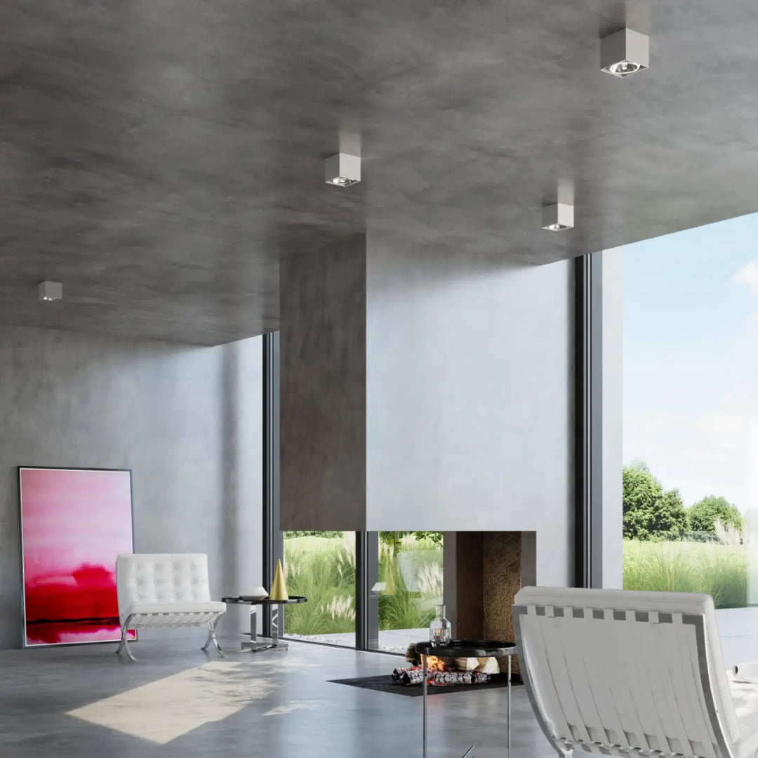 Minimalist white leather armchairs with tufted upholstery and slender metal legs complement plafonnier blake gris forme minimaliste plafonnier moderne