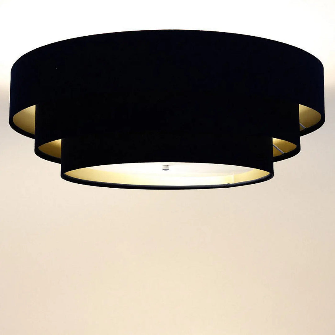 Luminaire plafonnier noir en velours avec doublure dorée et design moderne en cercles superposés triniti veloursstoff