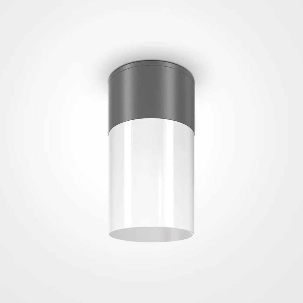 Plafonnier extérieur willis cylindrique avec corps en verre blanc translucide et dessus métallique gris mat offrant lumière dirigée