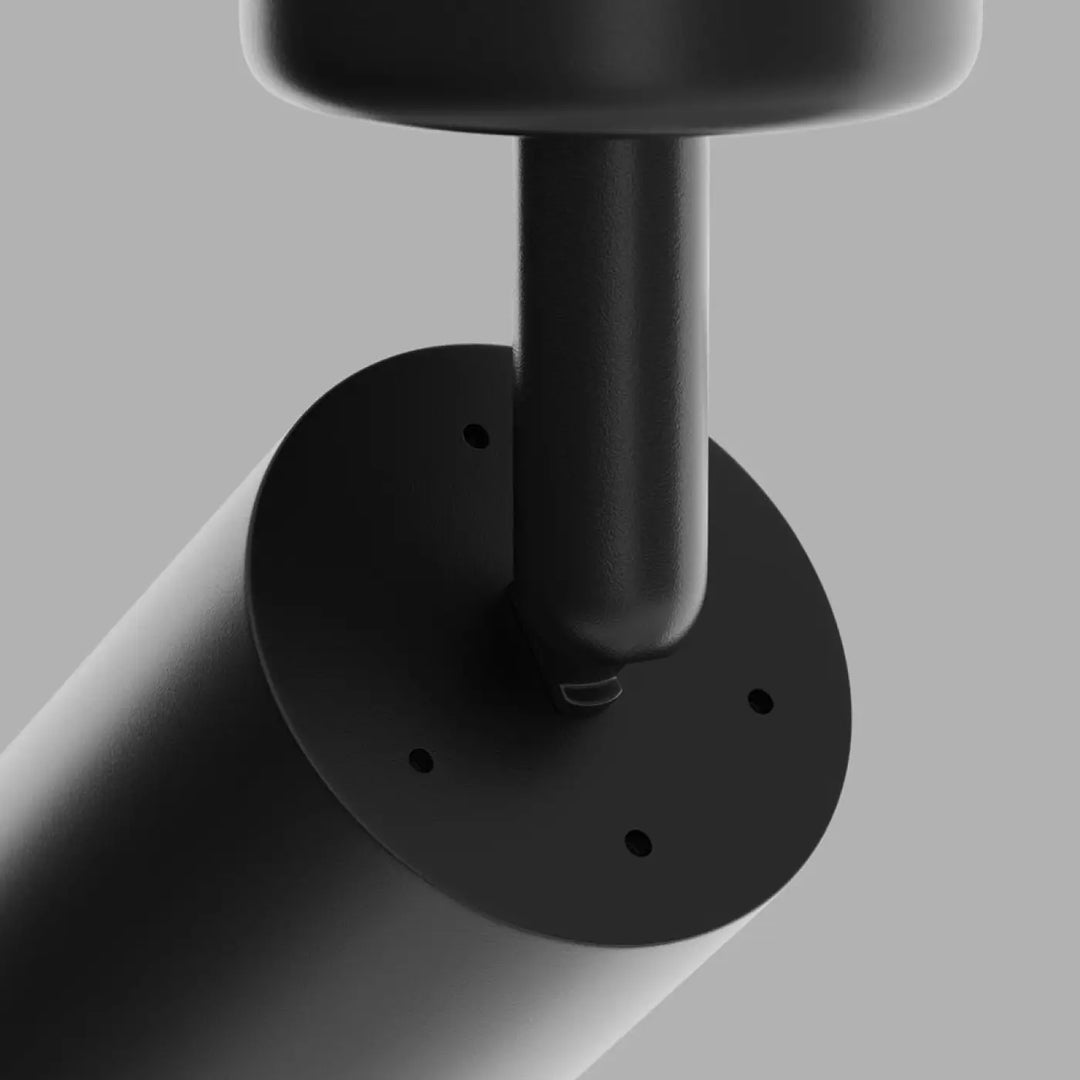 Spot directionnel noir cylindrique avec base ronde et quatre trous de fixation pour fixation au plafond