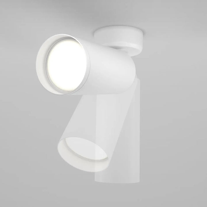 Spot directionnel blanc cylindrique à base ronde, design moderne, idéal pour un éclairage focus au plafond