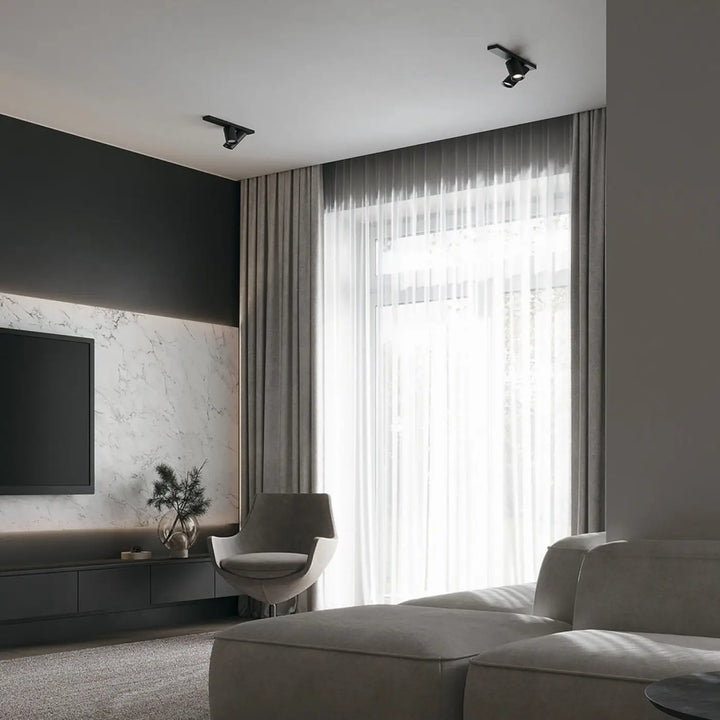 Spot double focus noire moderne avec longues bases et têtes orientables montée sur plafond blanc
