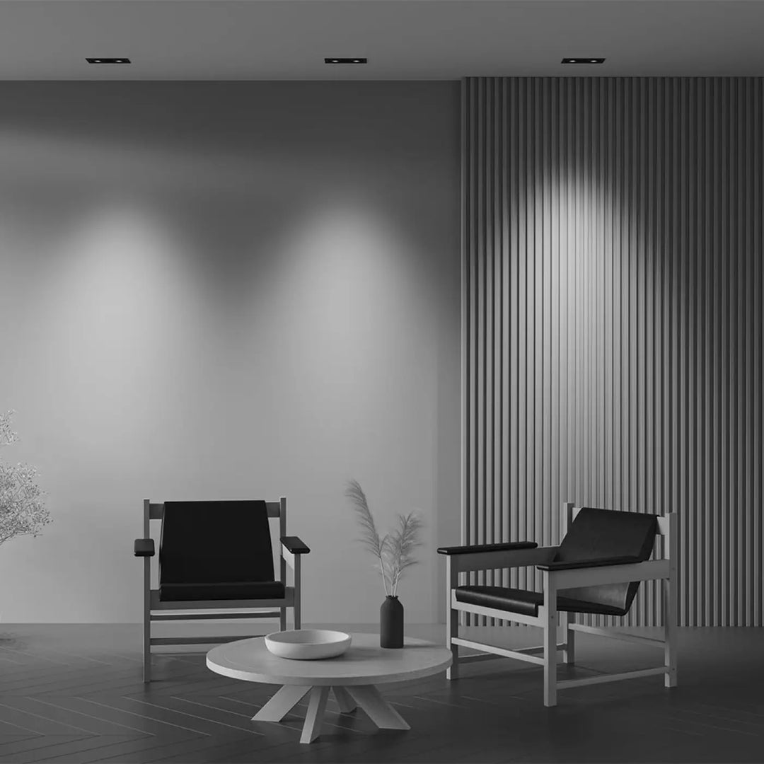 Minimalist black leather armchairs with slender wooden frames in a metal modern double led monochrome living space