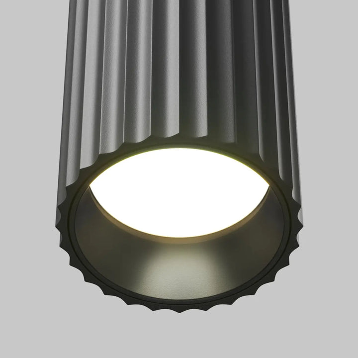 Spot calipso cylindre cannelé gris foncé avec éclairage ciblé et bord festonné disponible en trois finitions
