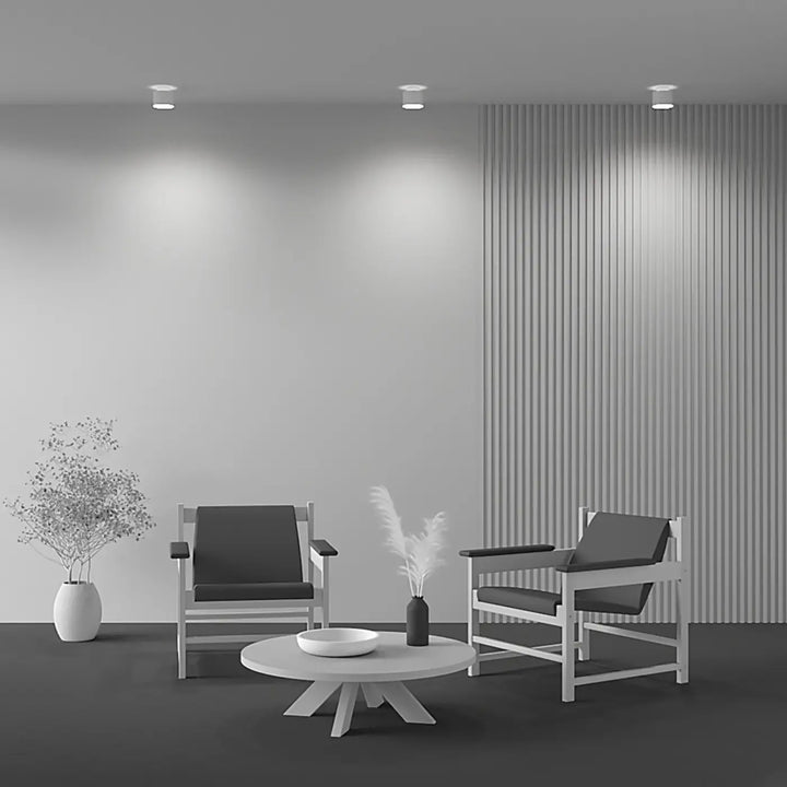 Table basse blanche minimaliste avec grand cylindre et base en acier noir pour spot saillie planet led