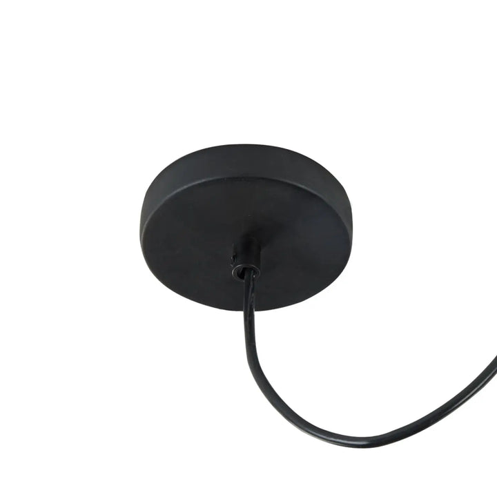 Suspension luminaire broni coupole en métal noir mat avec design minimaliste au-dessus d’une table en béton gris
