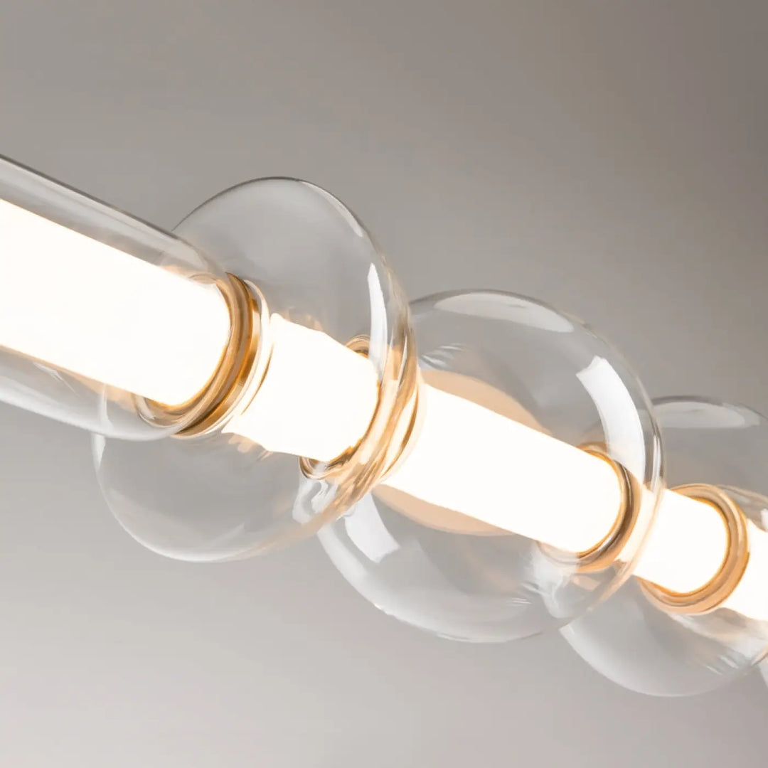 Suspension luminaire cosmo avec led linéaire, verre transparent en sphères bulbeuses et accents métalliques dorés