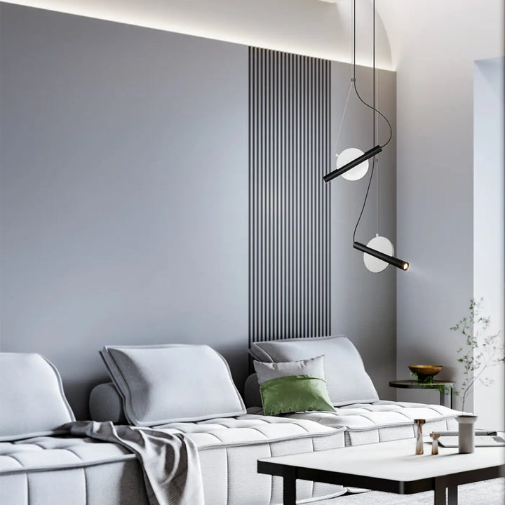 Suspension enigma cylindre en noir et blanc avec design minimaliste et orientation réglable au-dessus du sofa