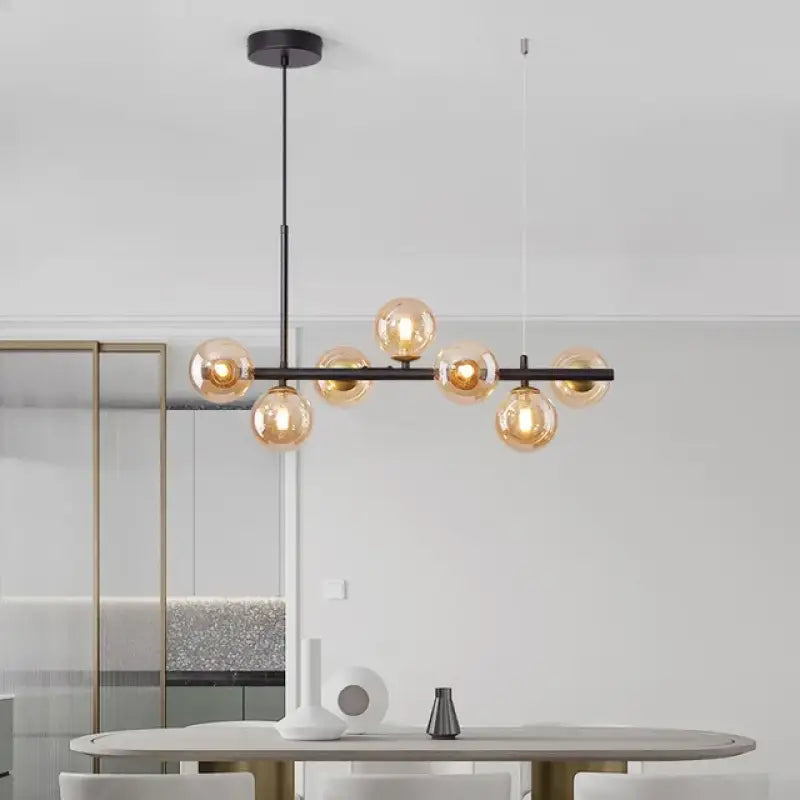 Suspension luminaire à boules de verre teinté sur un support noir

