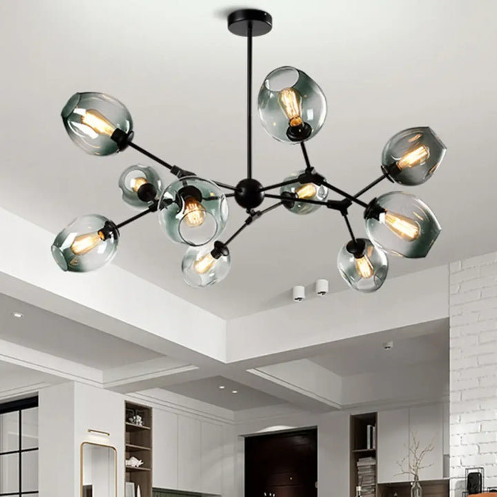Suspension luminaire alloy en métal noir moderne avec bras articulés vintage et globes de verre dépoli abritant des ampoules filament exposed