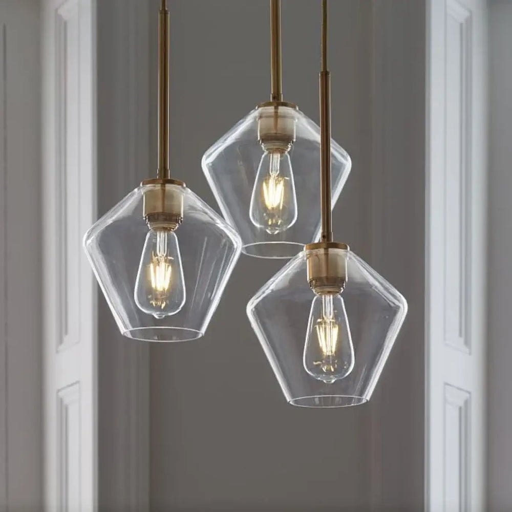 Suspension luminaire glazia avec verre transparent et métal doré en verre géométrique et ampoules à filament visible