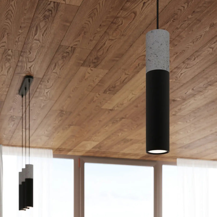 Suspension Borgio tube en acier noir et béton gris dans un intérieur contemporain